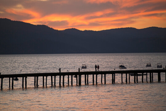 Silhouetted view of pier on South Lake Tahoe at sunset, California, USA