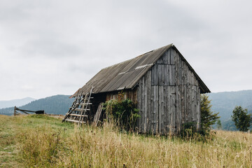 Picturesque mountain landscape with old wooden house