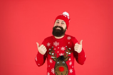 Fun activities and things to do. Hipster emotional bearded man wear winter sweater and hat red background. Happy new year concept. Join winter holiday party. Christmas Sweater Party. Winter outfit