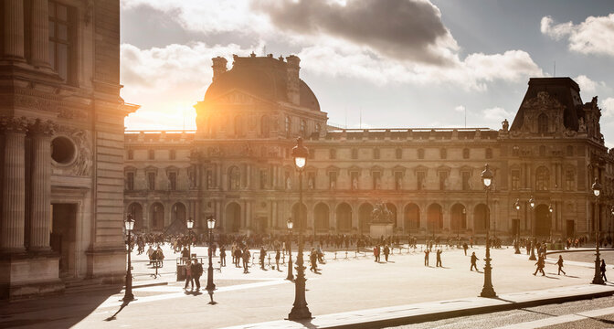 Silhouetted tourists at Louvre Museum, Paris, France