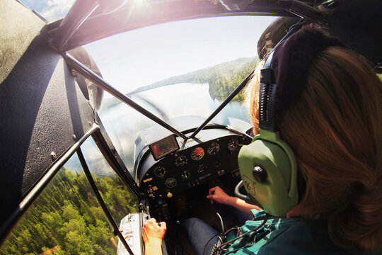 Woman flying floatplane, Talkeetna, Alaska, USA