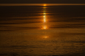 Sun trail in water during sunset