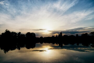 Beautiful golden sunset reflected in lake water. Poland, near Krakow