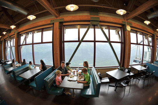 Family with three children having lunch in restaurant at Alyeska resort, Girdwood, Alaska, USA