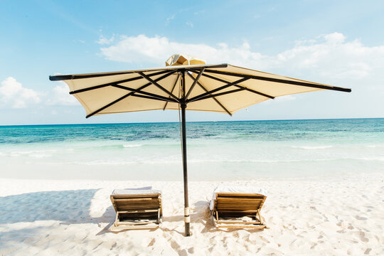 Beach umbrella and sun loungers at beach, Tulum, Riviera Maya, Mexico