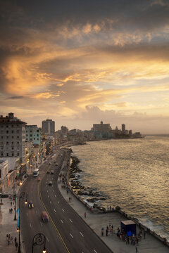 High angle view of waterfront traffic on El Malecon at dusk, Havana, Cuba