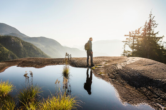 Man looking at view, Stawamus Chief, overlooking Howe Sound Bay, Squamish, British Columbia, Canada