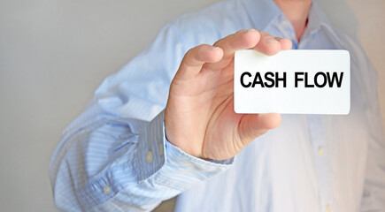 Business man holding a business card. The content of the lettering has implications for business concept and marketing.