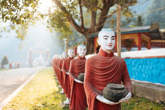 Row of buddhist monk statues holding ban bats, Kaw Ka Thawng Cave, Hpa An, Kayin State, Myanmar