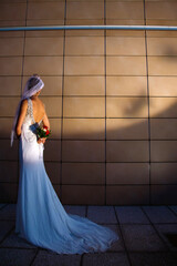 chica modelo con vestido de novia con ramo y velo
