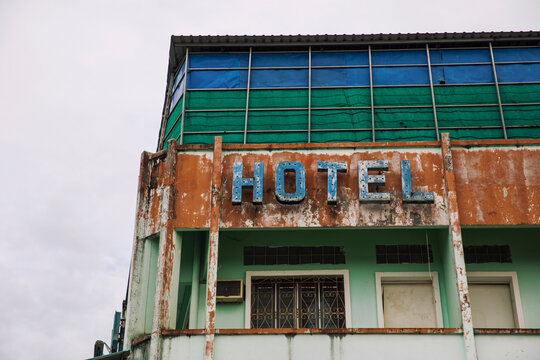 Abandoned hotel with rusting sign, Kampot, Kampong Cham province, Cambodia