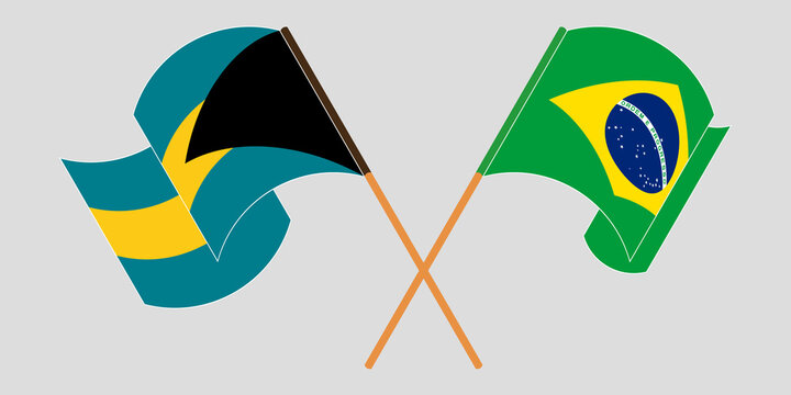 Crossed and waving flags of Bahamas and Brazil