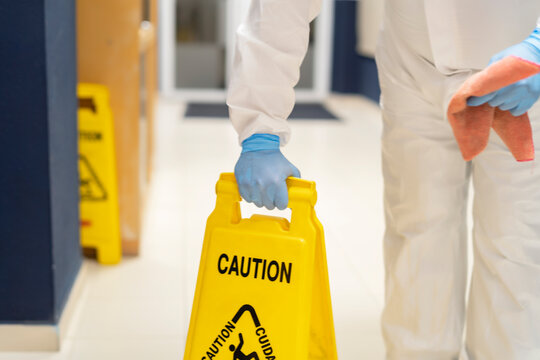 Cleaning Staff Holding Wet Floor Poster