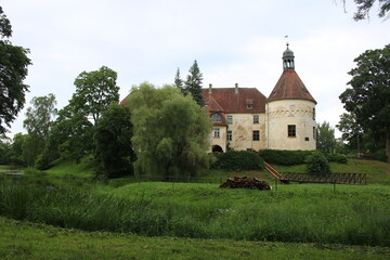 Fototapeta premium The old beautiful Jaunpils castle is landmark in the territory of Latvia on summer day 2020