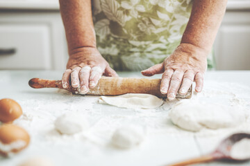 Woman kneading dough at home kitchen