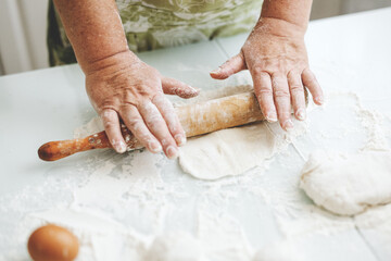 Woman kneading dough at home kitchen