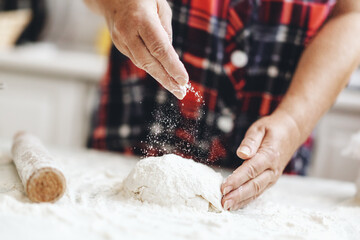 Woman kneading dough at home kitchen