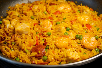 Sea Food Home made Paella Valenciana. Typical Spanish seafood paella in traditional pan. Macro close-up. Selective focus