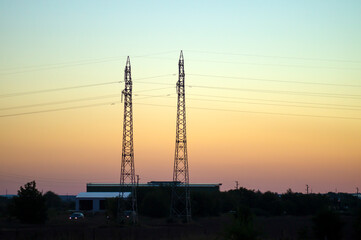 Electric poles against the sunset