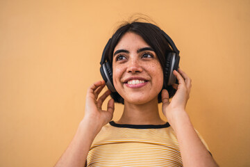 Young woman listening music with headphones.