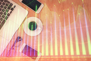 Double exposure of forex chart hologram over desktop with phone. Top view. Mobile trade platform concept.