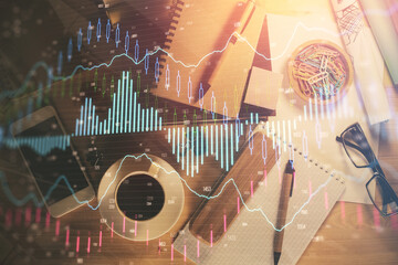 Double exposure of forex graph drawing and work table top veiw. Concept of financial analysis.