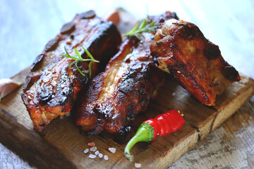 Selective focus. Macro. Baked meat ribs. Appetizing hot ribs baked in honey mustard sauce with chili pepper. BBQ ribs.