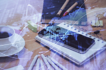 Double exposure of forex chart drawing and cell phone background. Concept of financial trading