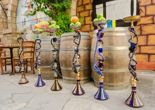 View of shisha with fruits on top in front of barrels at restaurant