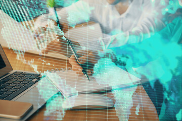 Double exposure of business theme drawing over people taking notes background. Concept of financial world