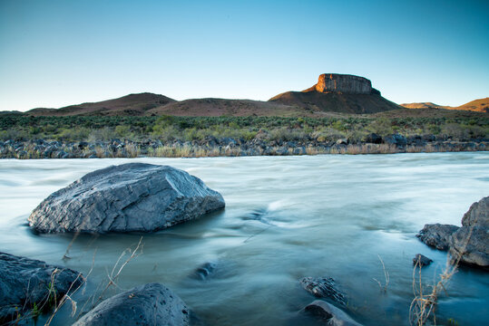 View of river with Devils Tower in background
