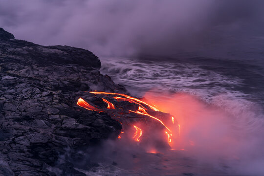 View of molten lava flowing in sea