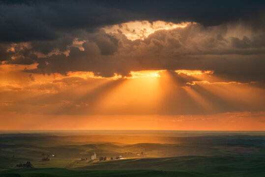 Scenic View Of Rural Landscape Against Cloudy Sky During Sunset