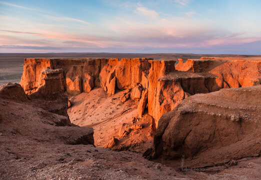 Scenic view of Flaming Cliffs against cloudy sky