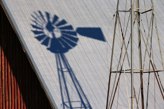 Shadow of windmill on barn