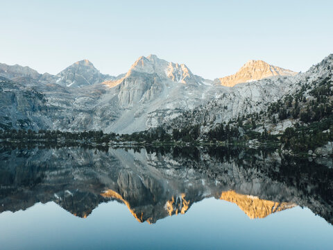 Reflection of Painted Lady mountain in Rae Lakes during sunset