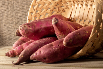 Sweet potato in basket on jute background in Brazil