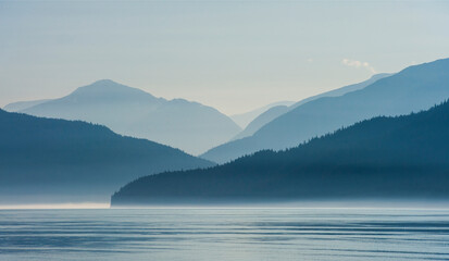 Scenic view of fog over mountain range and sea