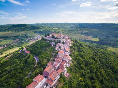 Aerial view of village against cloudy sky