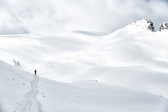 Scenic view of man skiing on mountain covered with snow