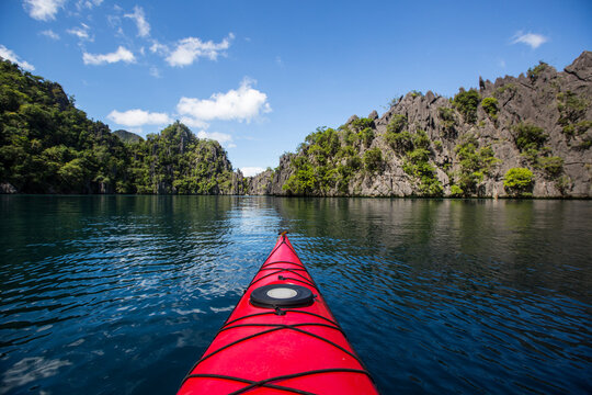 Kayak boat in Coron Island with trees and mountain in background