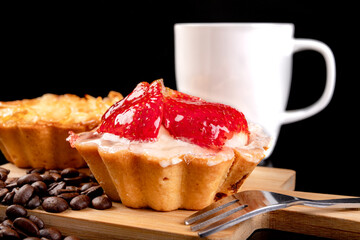 Tasty cupcake with fruit on a wooden board. Dessert prepared for serving.