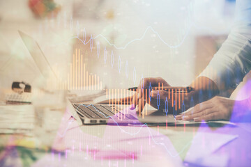 Multi exposure of woman hands typing on computer and financial chart hologram drawing. Stock market...