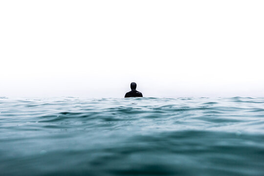 Rear view of man swimming in sea