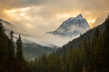 Scenic view of mountain peak against cloudy sky during sunset