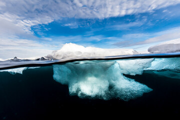 View of iceberg against cloudy sky
