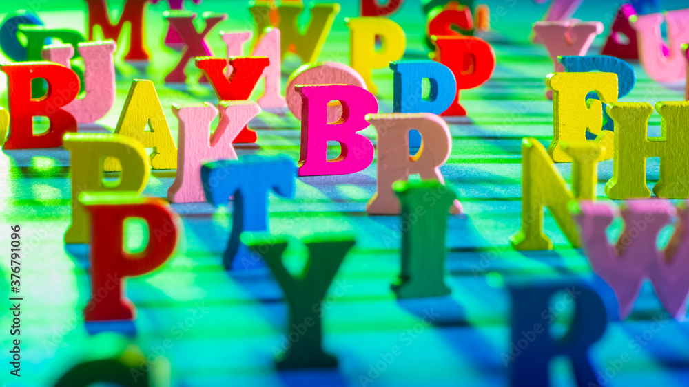 Fototapete the letters of the latin alphabet stand on a green background. colorful learning concept. english le
