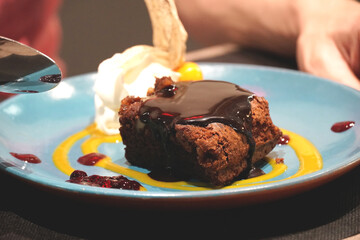brownie on blue plate with cream. flat lay flat design