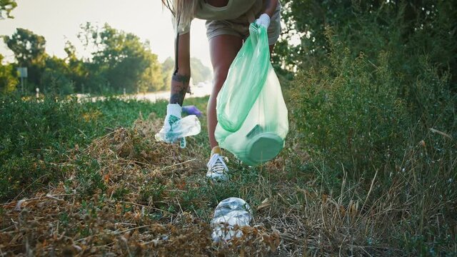 Volunteers cleaning park and collecting waste for nature conservation, close up