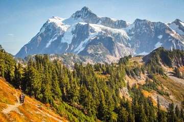 Rear view of hikers walking on mountain trail